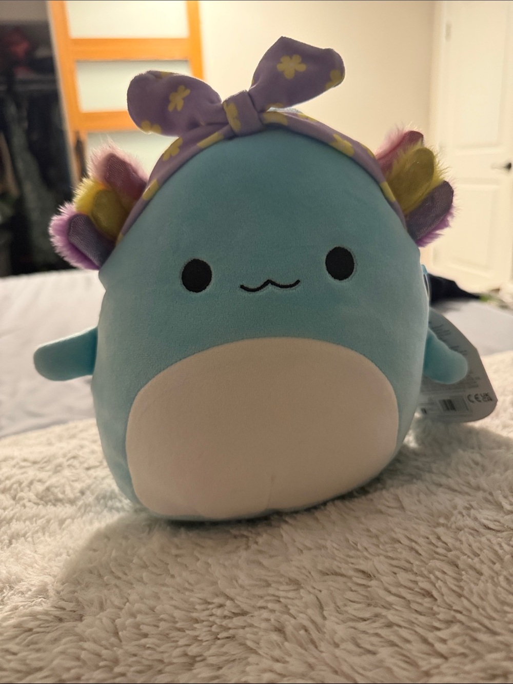 Squishmallows Blue Axolotl Bib Plush with Purple Floral Headband
